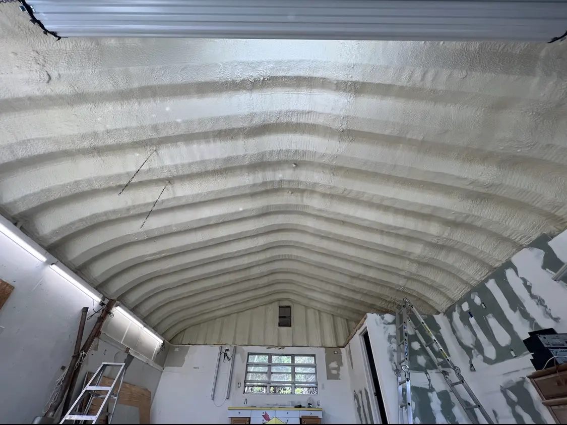 Spray polyurethane foam applied to the underside of a metal roof deck in Medford